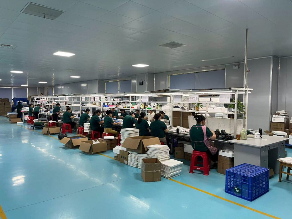 Workers assemble portable healthcare devices on final production assembly line